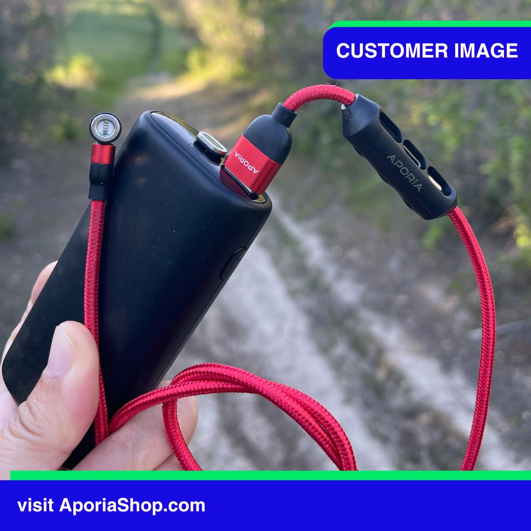 Customer image of a person holding red cord and black battery, 5Pin 540° Rotating 3-in-1 Magnetic Charging Cable.