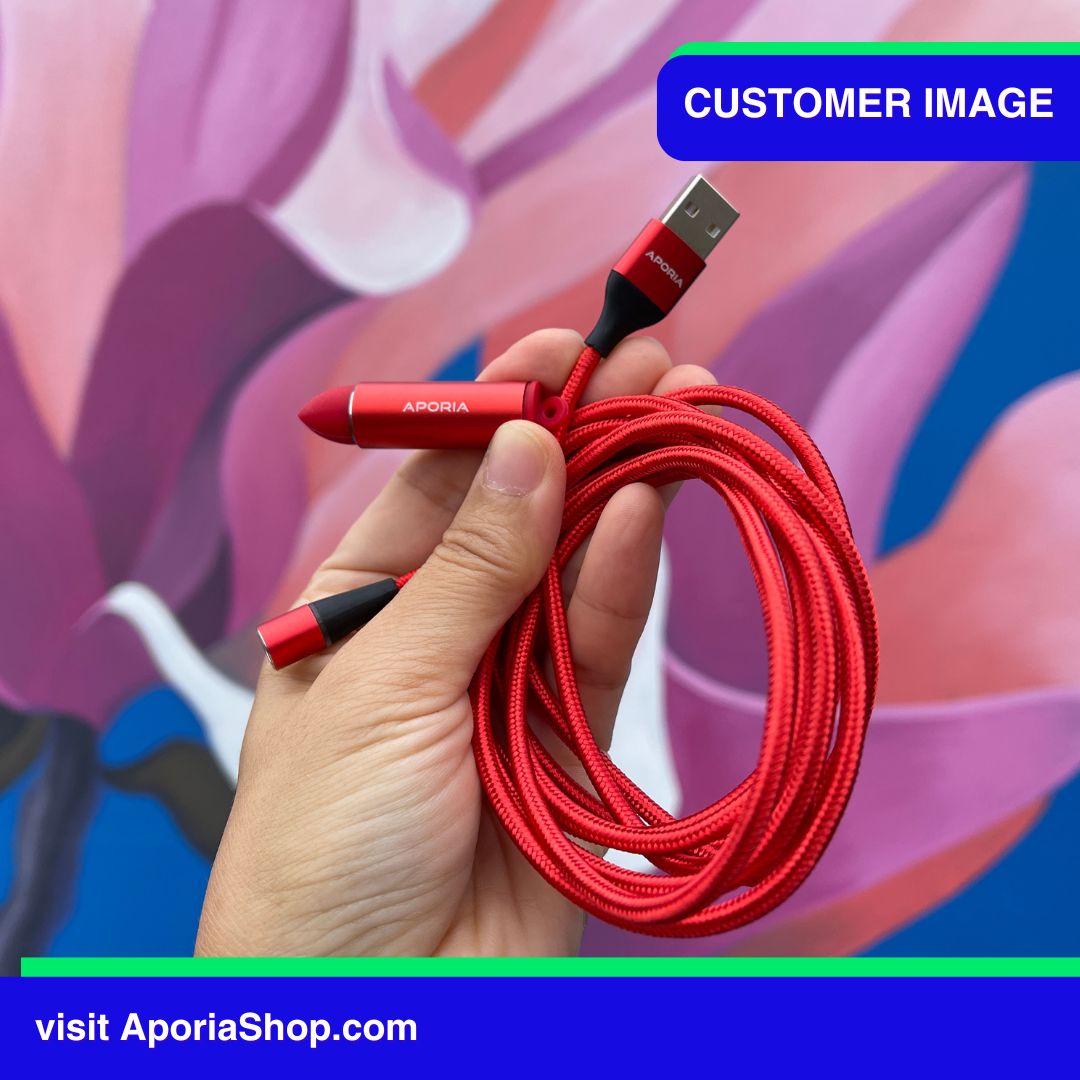 Image of a customer holding a sleek red lightning cable designed with 7PIN 360 Rotating Magnetic Charging capability.