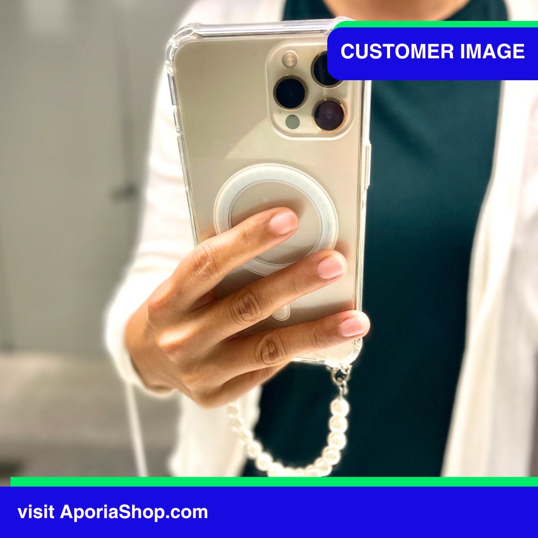 Image of customer holding Aporia MagSafe Clear Case - Pearl Wristlet Strap for iPhone 15/14/13/12 inside fitting room