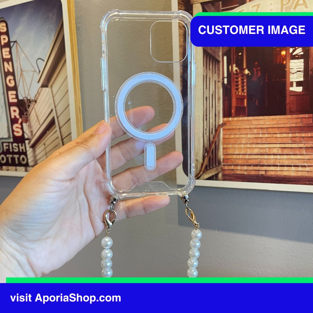 Image of customer holding Aporia MagSafe Clear Case - Pearl Wristlet Strap for iPhone 15/14/13/12 while at the art museum featuring stunning Art Paintings