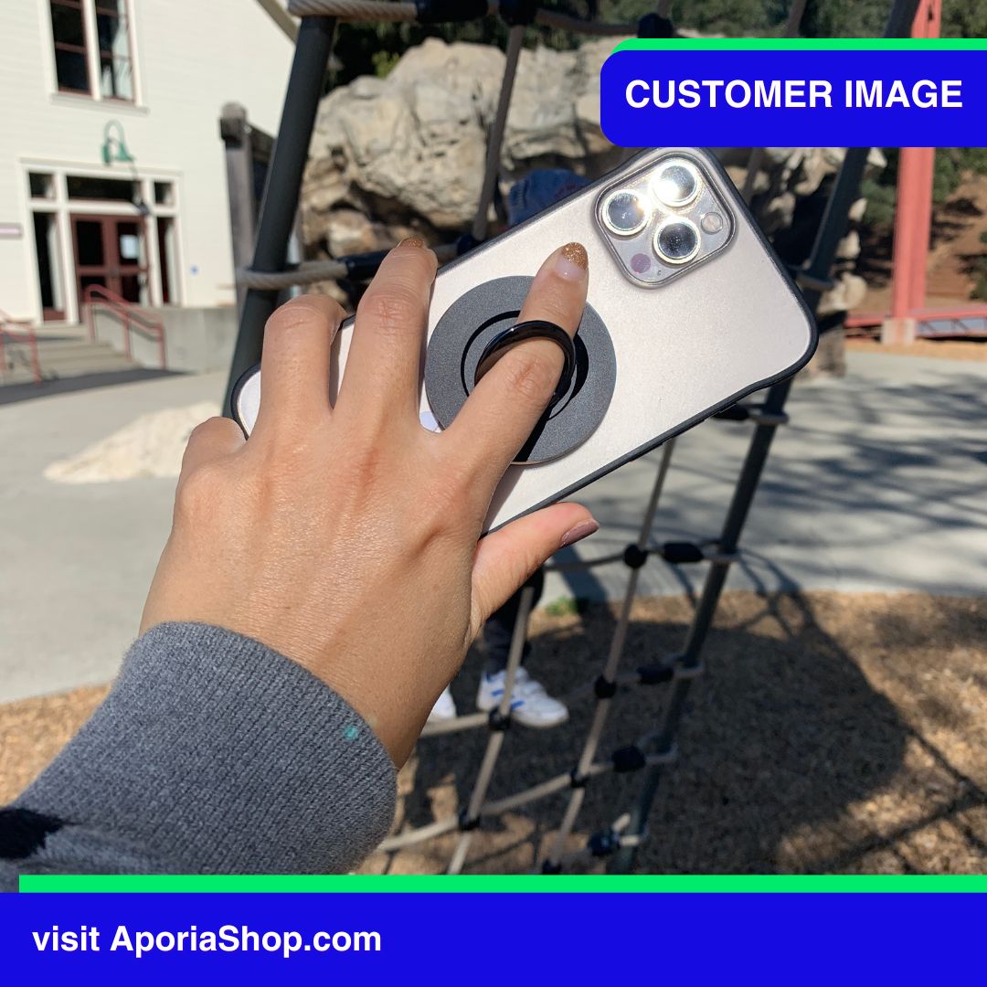Image of customer holding MagSafe Magnetic Ring Finger Grip Holder with iPhone at Playground