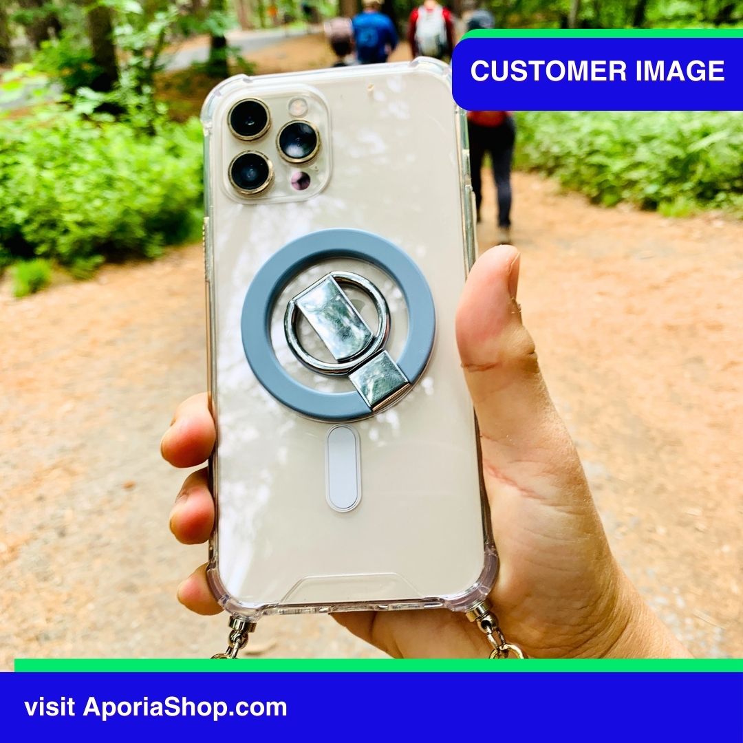 Image of customer holding MagSafe Magnetic Ring Finger Holder Stand while climbing mountain